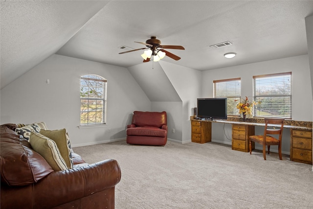 carpeted office with a textured ceiling, vaulted ceiling, and ceiling fan