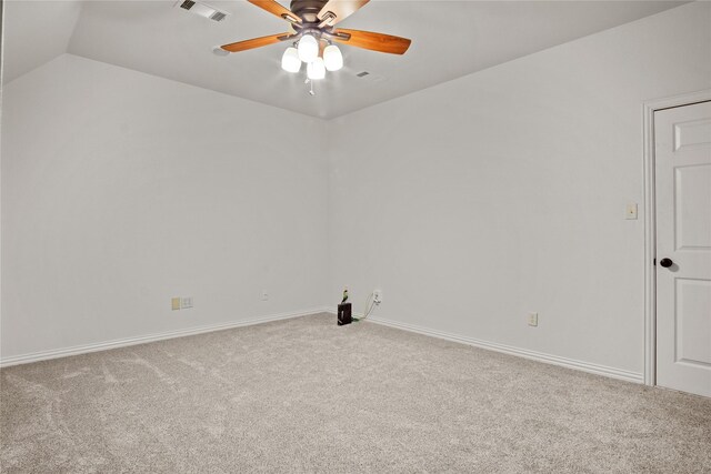 empty room featuring carpet floors, vaulted ceiling, and ceiling fan