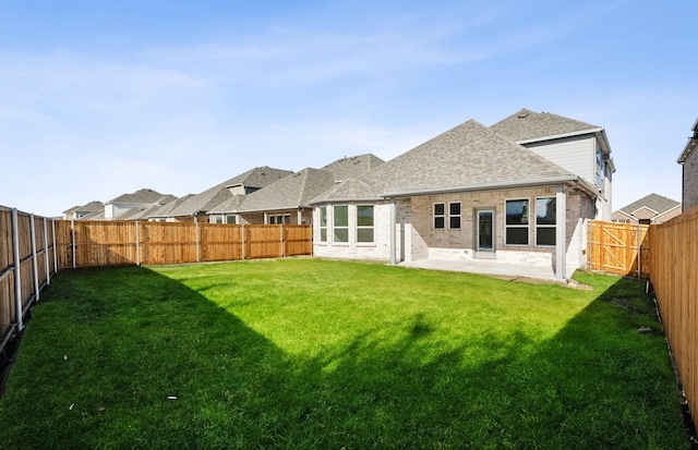 back of property featuring a yard and a patio area