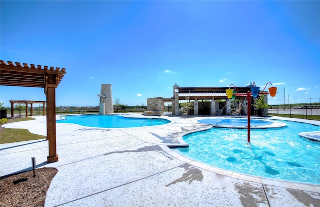 view of swimming pool featuring pool water feature, a hot tub, a pergola, and a patio area