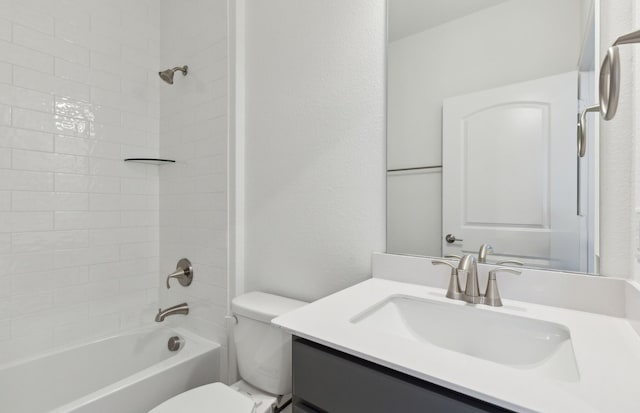 full bathroom featuring tiled shower / bath combo, vanity, and toilet