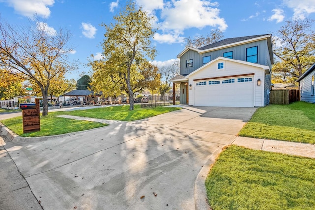 view of front of home with a garage and a front lawn