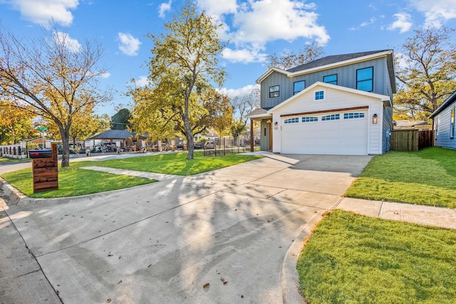 1724 S Hughes Ave, Fort Worth, TX 76105 - view of front of house with board and batten siding, concrete driveway, and an attached garage