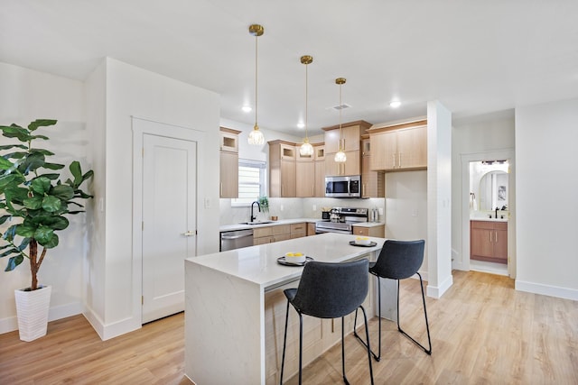 1724 S Hughes Ave, Fort Worth, TX 76105 - kitchen with stainless steel appliances, light wood-style floors, glass insert cabinets, a kitchen island, and decorative light fixtures