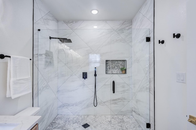 bathroom featuring vanity, toilet, and a shower with door