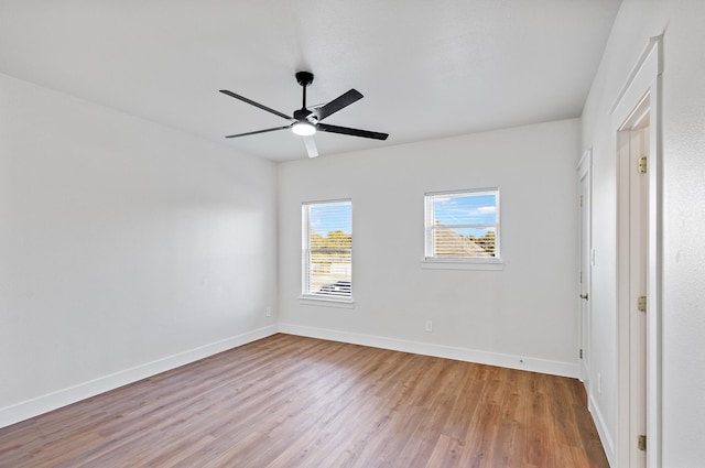 empty room with ceiling fan and light wood-type flooring