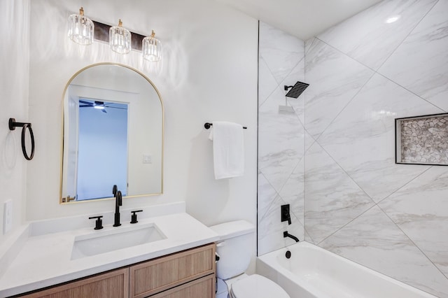 full bathroom with vanity, tiled shower / bath, and toilet