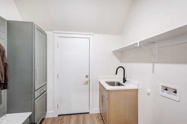 1724 S Hughes Ave, Fort Worth, TX 76105 - washroom featuring cabinet space, hookup for a washing machine, light wood-type flooring, and wet bar