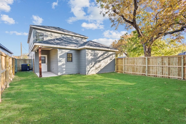 back of house with a patio, a lawn, and central air condition unit