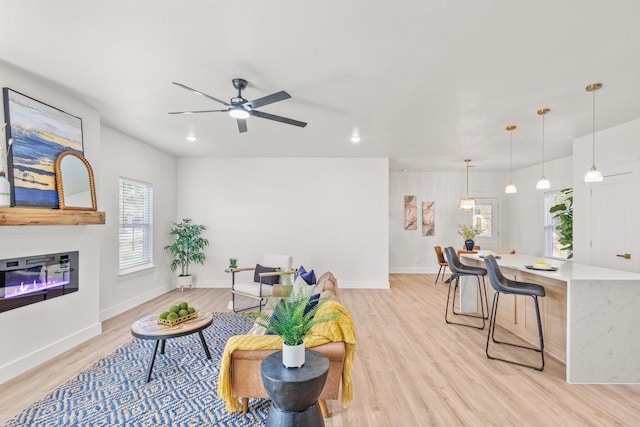 1724 S Hughes Ave, Fort Worth, TX 76105 - living area with light wood finished floors, ceiling fan, a glass covered fireplace, and recessed lighting
