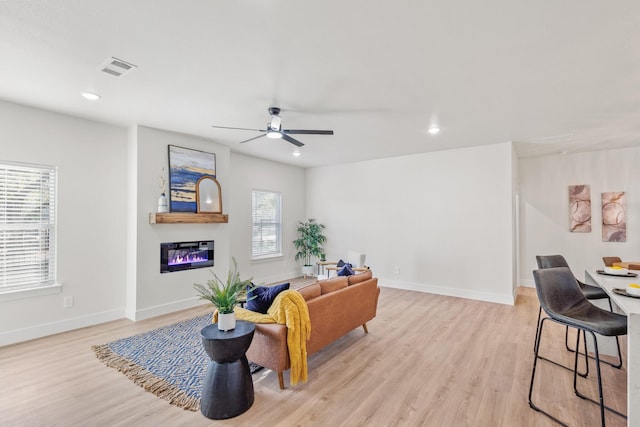 1724 S Hughes Ave, Fort Worth, TX 76105 - living room with light wood finished floors, a glass covered fireplace, recessed lighting, and ceiling fan