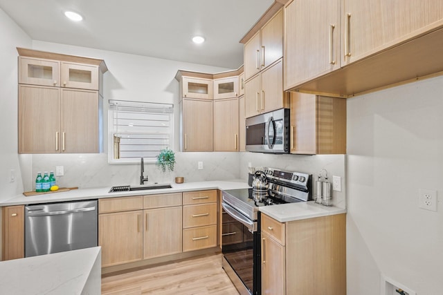 1724 S Hughes Ave, Fort Worth, TX 76105 - kitchen featuring appliances with stainless steel finishes, light brown cabinetry, light wood-type flooring, decorative backsplash, and recessed lighting