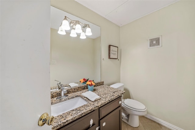 bathroom with tile patterned flooring, vanity, and toilet