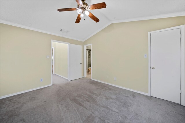 carpeted empty room featuring crown molding, ceiling fan, and lofted ceiling