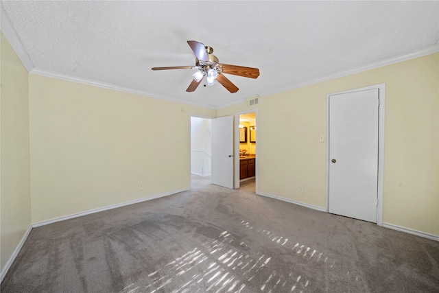 interior space featuring ensuite bath, ceiling fan, a textured ceiling, carpet, and ornamental molding