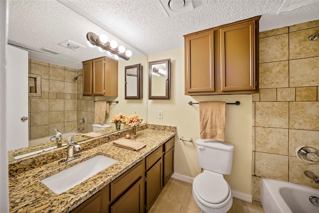 full bathroom with tile patterned flooring, a textured ceiling, toilet, vanity, and tiled shower / bath