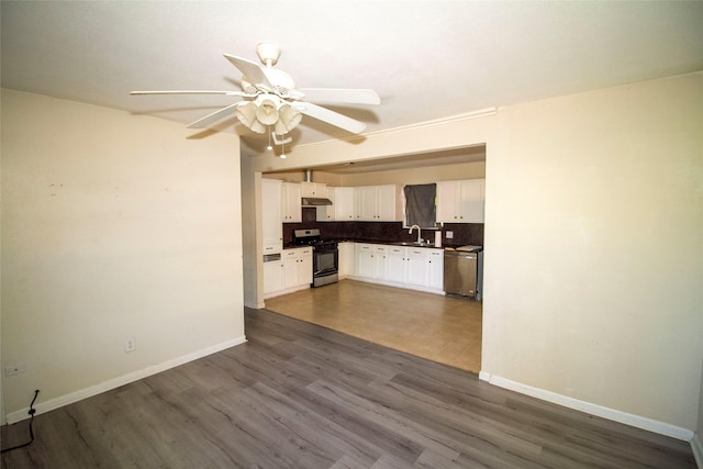 kitchen with sink, ceiling fan, appliances with stainless steel finishes, white cabinetry, and backsplash