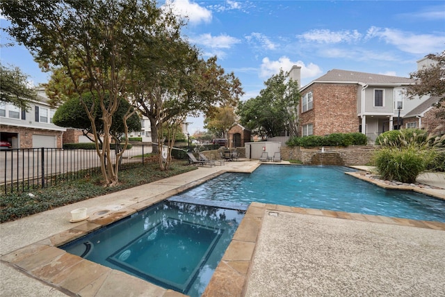 view of swimming pool featuring an in ground hot tub and a patio area