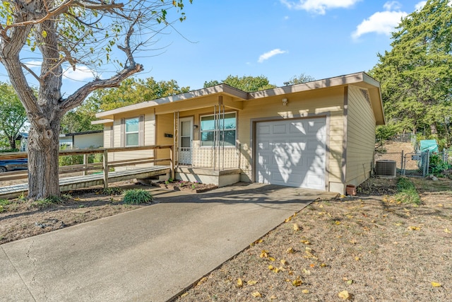 view of front of property featuring a garage and central air condition unit