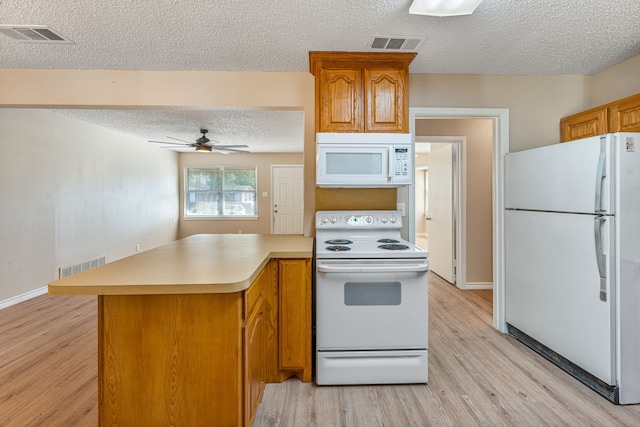 kitchen featuring white appliances, light hardwood / wood-style flooring, ceiling fan, a textured ceiling, and kitchen peninsula