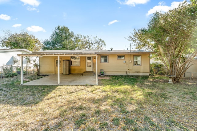 back of house featuring a yard and a patio