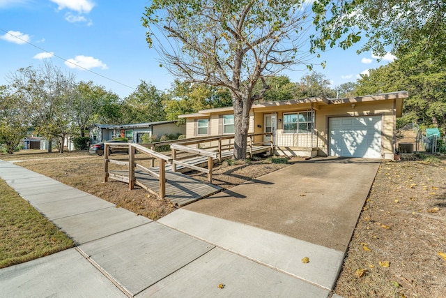 view of front of house featuring a garage and central air condition unit