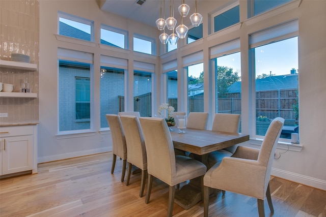 dining room featuring light hardwood / wood-style flooring and a notable chandelier