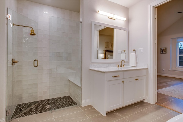 bathroom with walk in shower, vanity, and hardwood / wood-style flooring