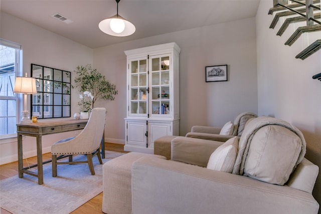 home office with light hardwood / wood-style floors