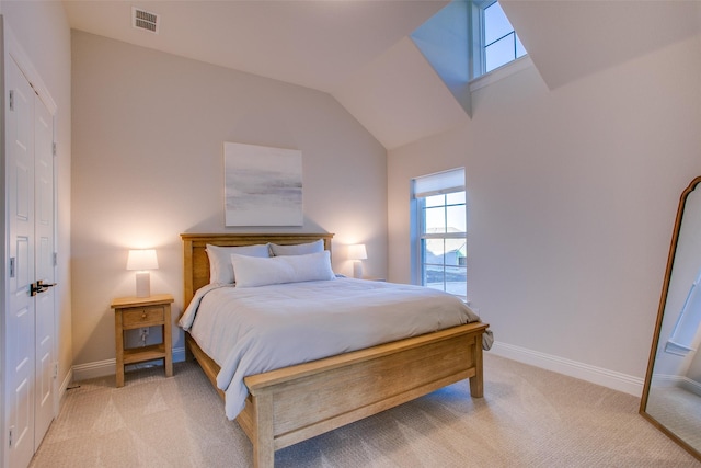 bedroom featuring light colored carpet and lofted ceiling