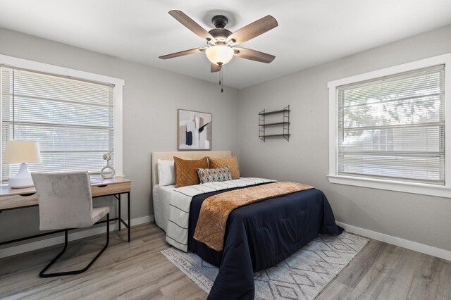 bedroom with ceiling fan and light hardwood / wood-style floors