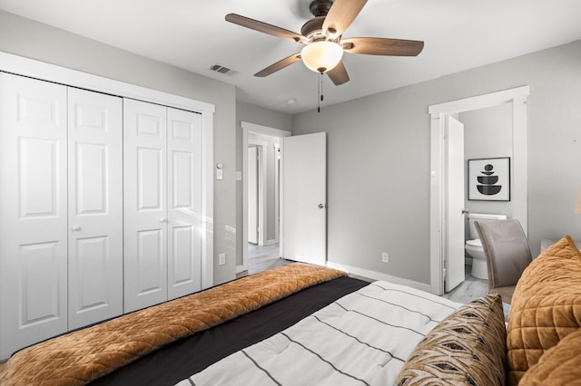 bedroom with a closet, ensuite bathroom, and ceiling fan