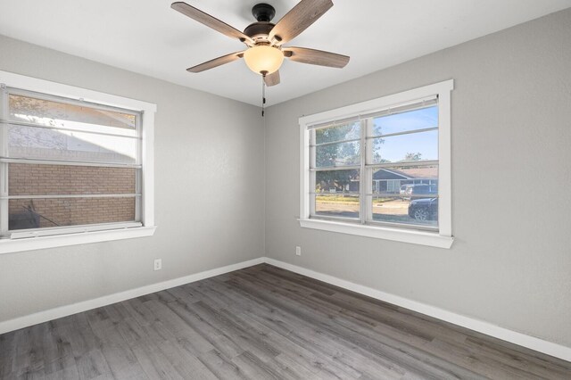 spare room featuring ceiling fan and dark wood-type flooring