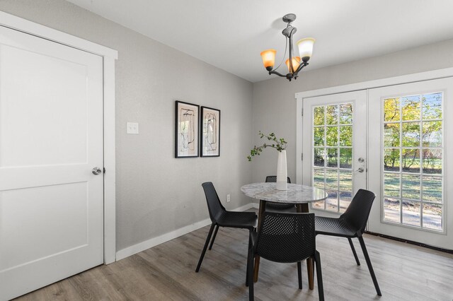 dining room with a notable chandelier and light hardwood / wood-style floors