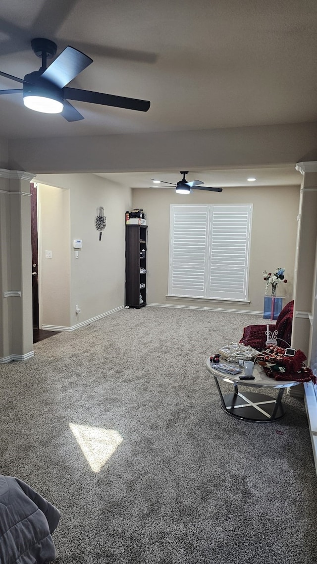 interior space featuring ceiling fan and carpet