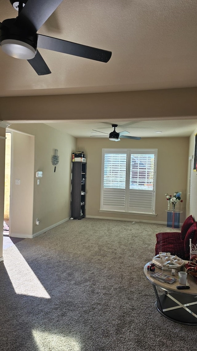 sitting room with carpet flooring and ceiling fan