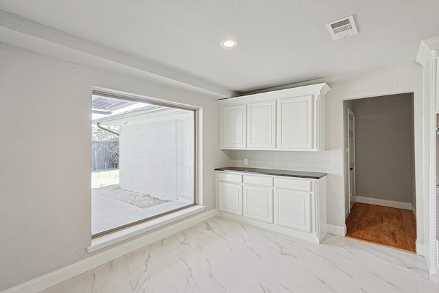 interior space featuring white cabinetry