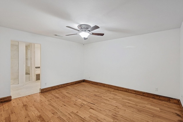 spare room with light hardwood / wood-style flooring and ceiling fan