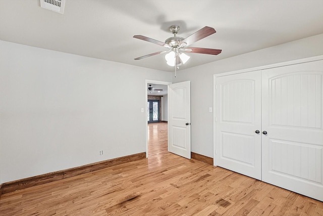 unfurnished bedroom with light wood-type flooring, a closet, and ceiling fan