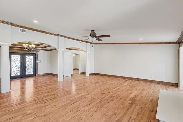 unfurnished living room featuring crown molding, french doors, ceiling fan with notable chandelier, and light wood-type flooring