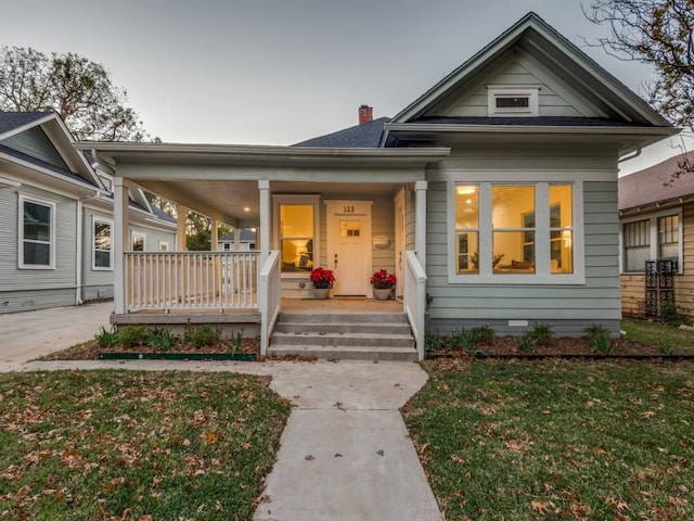 bungalow-style home with a front yard and a porch