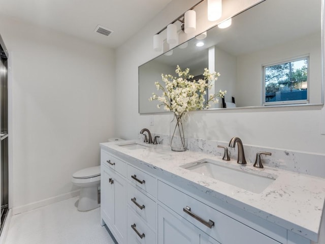 bathroom featuring vanity and toilet