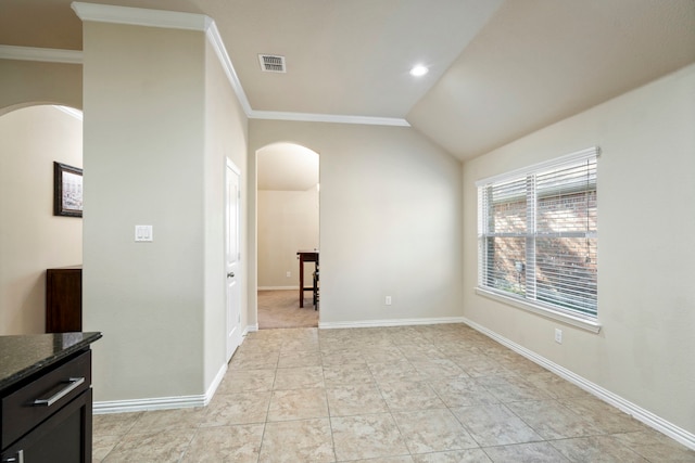 tiled spare room with vaulted ceiling and crown molding