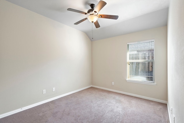 spare room featuring carpet flooring, ceiling fan, and vaulted ceiling