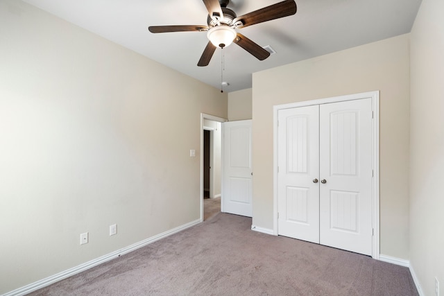 unfurnished bedroom with ceiling fan, a closet, and light carpet