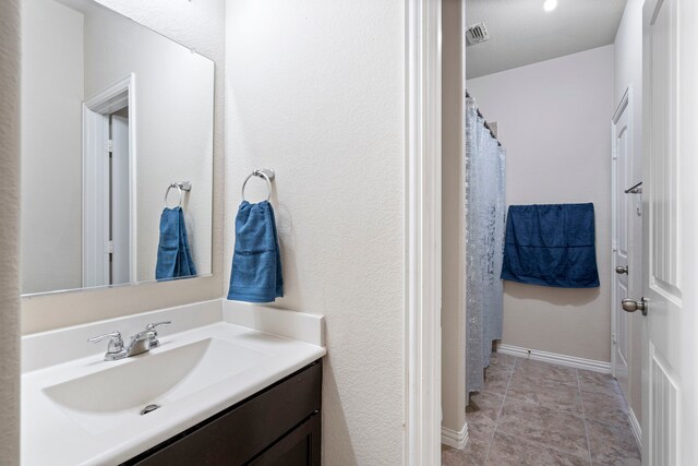 bathroom with tile patterned flooring and vanity