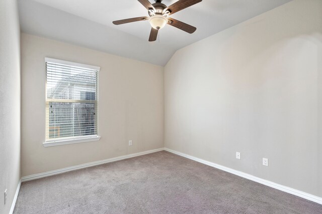 unfurnished room with carpet flooring, a healthy amount of sunlight, and vaulted ceiling