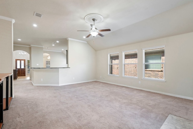 unfurnished living room with crown molding, light colored carpet, and vaulted ceiling