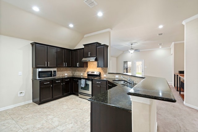 kitchen featuring vaulted ceiling, ceiling fan, ornamental molding, appliances with stainless steel finishes, and kitchen peninsula