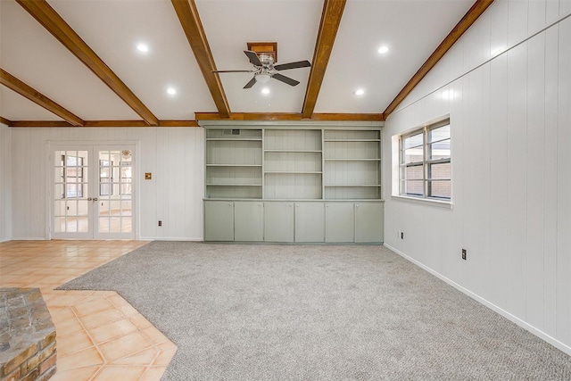 unfurnished living room with french doors, ceiling fan, light carpet, and vaulted ceiling with beams